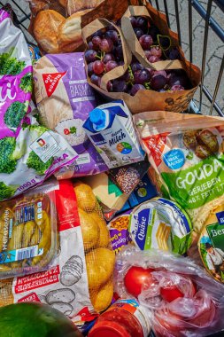 Berlin, Germany - August 8, 2022: View into a full shopping cart with various products for daily needs.