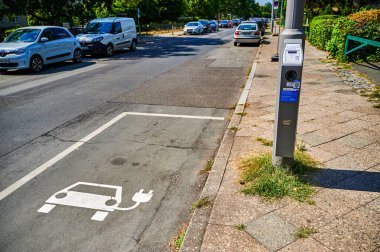 Berlin, Germany - August 11, 2022: View to a public charging station for electric cars at a lantern.
