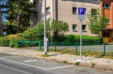 Berlin, Germany - August 11, 2022: View to a public charging station for electric cars at a lantern.