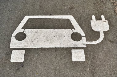 Berlin, Germany - August 11, 2022: Photo of a logo for a charging station for electric cars painted on a street.