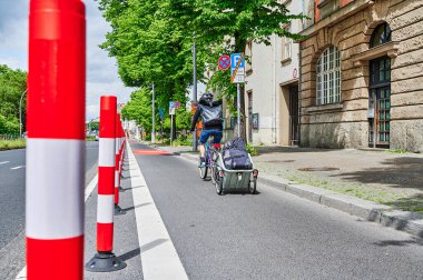 Berlin, Germany - May 29, 2022: Cyclist in a protected bike lane on a main street to improve road safety.
