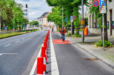Berlin, Germany - May 29, 2022: Cyclists in a protected bike lane on a main street to improve road safety.