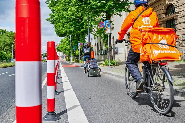 Berlin, Germany - May 29, 2022: Cyclists in a protected bike lane on a main street to improve road safety.