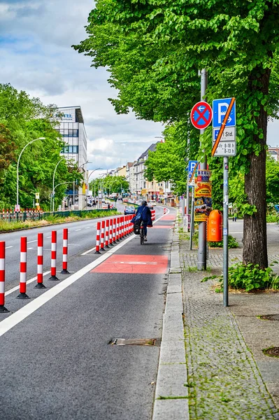 Berlin, Germany - May 29, 2022: Cyclist in a protected bike lane on a main street to improve road safety.