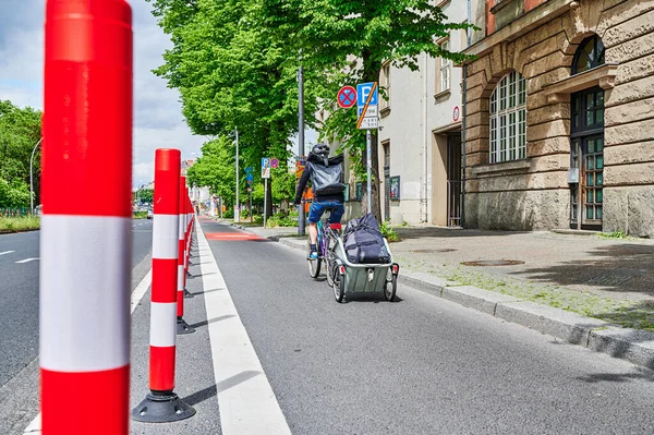 Berlin, Germany - May 29, 2022: Cyclist in a protected bike lane on a main street to improve road safety.