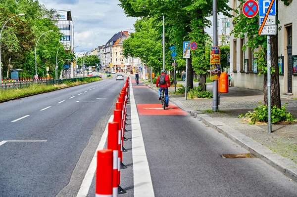 Berlin, Germany - May 29, 2022: Cyclists in a protected bike lane on a main street to improve road safety.