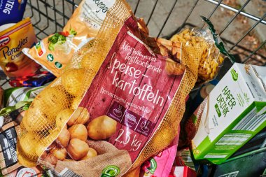 Berlin, Germany - September 1, 2022: View into a full shopping cart with various products for daily needs.