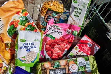 Berlin, Germany - September 1, 2022: View into a full shopping cart with various products for daily needs.