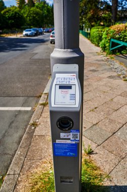 Berlin, Germany - August 11, 2022: View to a public charging station for electric cars at a lantern.