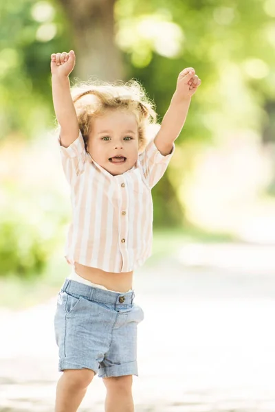 可愛いです男の子とともに巻きブロンド髪遊びで公園 — ストック写真