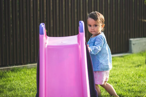 Pouco Bonito Menina Jogar Slide Fazer Grimace Enquanto Ela Joga — Fotografia de Stock