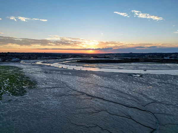 Mud flats of low tide river at sunset