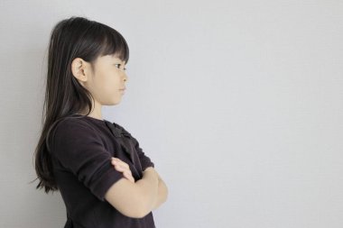 Japon kız kollarını kavuşturuyor (profil) (7 yaşında))