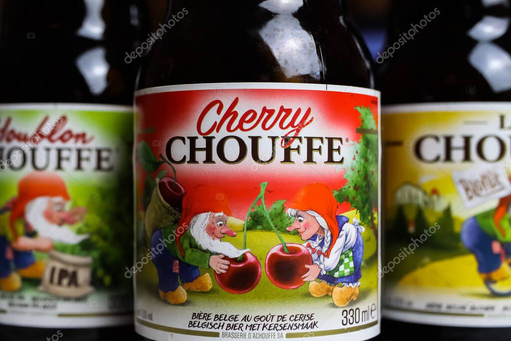 Ghent, Belgium - June 9. 2021: Closeup of bottle label with logo lettering of typical cherry fruit flavored belgian beer Chouffe with fancy funny dwarfs