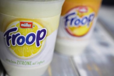 Viersen, Almanya - 9 Aralık. 2021: Plastik bardaktaki etiketin üzerinde Muller Froop meyveli yoğurt çölü logosu var