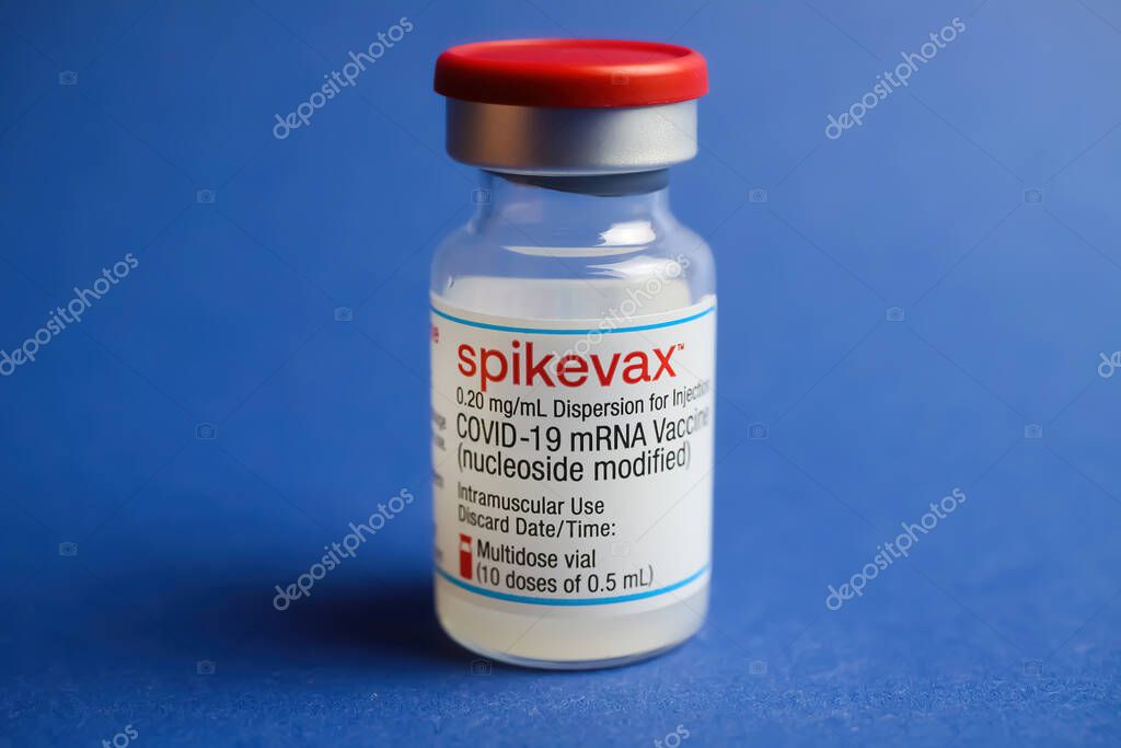 Viersen, Germany - January 9. 2022: Closeup of one isolated mRNA vaccination serum vial Moderna Spikevax , blue background