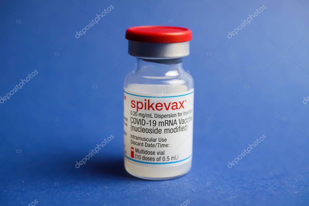 Viersen, Germany - January 9. 2022: Closeup of one isolated mRNA vaccination serum vial Moderna Spikevax , blue background