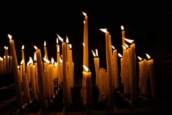 Closeup Group White Yellow Wax Candles Burning Wind Dark Black — Stock Photo, Image