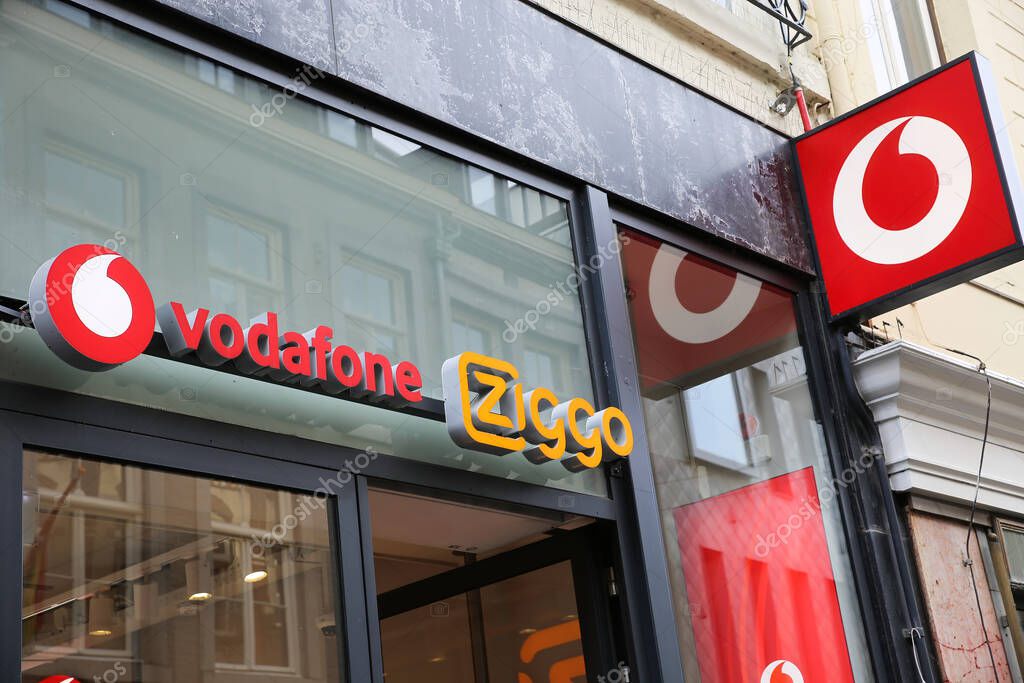 Maastricht, Netherlands - February 13. 2022: View on store entrance with logo lettering of vodafone and ziggo