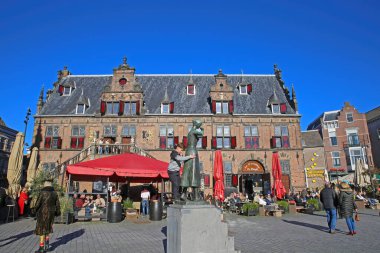 Nijmegen (grote markt), Hollanda - 27 Şubat. 2022: Güneşli bir günde kafeler, restoranlar ve eski ortaçağ binalarıyla dolu işlek pazar meydanını görmek