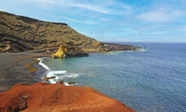 Etkileyici engebeli sarp kayalıklarla çevrili güzel tenha bir göl, farklı renkler, kırmızı kaya, boş siyah kumsal - El Golfo, Lanzarote