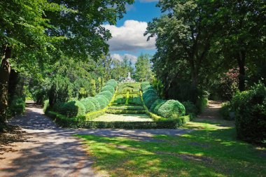 Beautiful old green abbey monastery garden park in summer, holy heart of jesus statue on hill, boxwood hedges forming latin christian cross  - Steyl (Venlo Tegelen), Netherlands