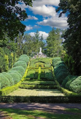 Beautiful old green abbey monastery garden park in summer, holy heart of jesus statue on hill, boxwood hedges forming latin christian cross  - Steyl (Venlo Tegelen), Netherlands