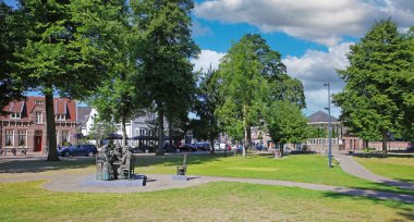 Nuenen (Eindhoven), Netherlands - July 9. 2022: Beautiful dutch town park  with bronze sculpture still life after painting of Vincent van Gogh the potato eaters