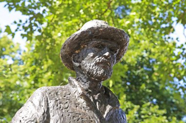 Nuenen (Eindhoven), Netherlands - July 9. 2022: Closeup of isolated painter Vincent van Gogh bronze sculpture in dutch park