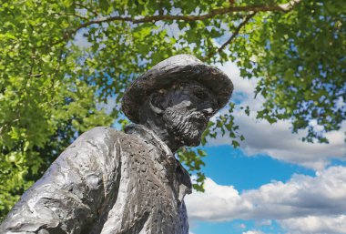 Nuenen (Eindhoven), Netherlands - July 9. 2022: Closeup of isolated painter Vincent van Gogh bronze sculpture in dutch park