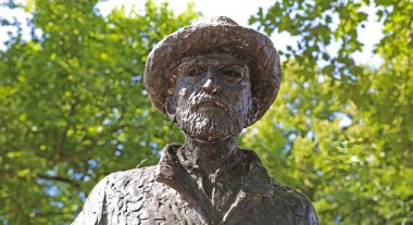 Nuenen (Eindhoven), Netherlands - July 9. 2022: Closeup of isolated painter Vincent van Gogh bronze sculpture in dutch park