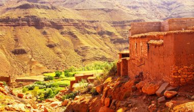 Hiking through idyllic beautiful lonely old clay house berber villages in high Atlas mountains valley - Toubkal, Morocco