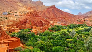 Beautiful moroccan  red mountain valley landscape, green oasis, historical clay stone berber town - Morocco, High Atlas mountains, Tamellalt
