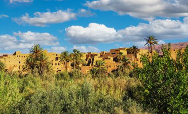 Beautiful idyllic Atlas mountains palm tree oasis valley, typical moroccan clay house kasbah village - Tinghir (Tinerhir), Morocco