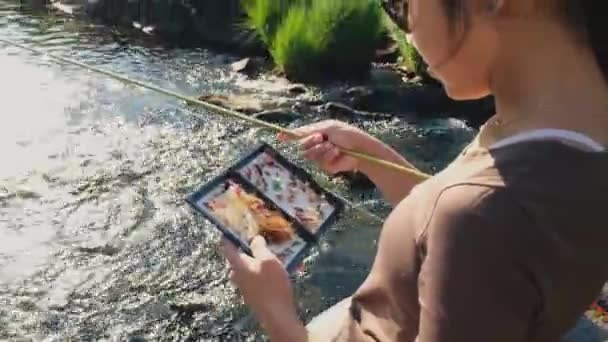 Close Asian Female Selecting Fly Fishing Fly Box — Stock video