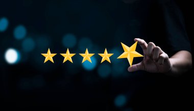 Businessman holding and input  yellow star to five stars for customer satisfaction after use product and service concept