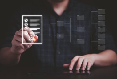 Hand using electronic pen for signature to document on  virtual screen and document for online approve paperless quality assurance and ERP management concept.