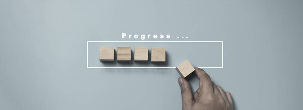 Hand putting and array wooden cube stacking for job and technology progress update concept.