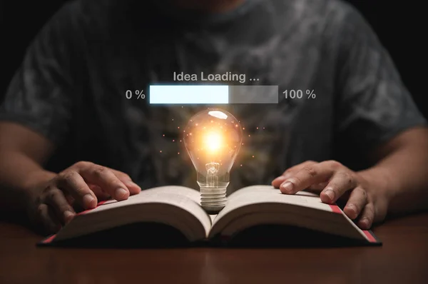 Glowing lightbulb on open book with virtual loading idea bar for creative thinking of problem solving and education knowledge concept.