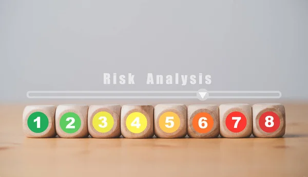 Risk rating from low to high number print on wooden cube block for risk assessment analysis and management concept.