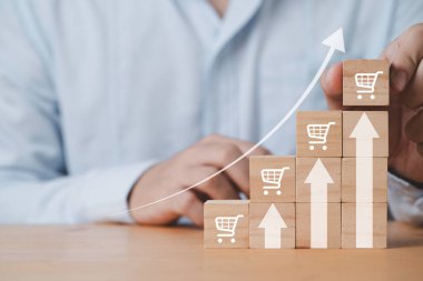 Businessman stacking increasing shopping trolley cart with up arrow  for business marketing sale volume growth concept.