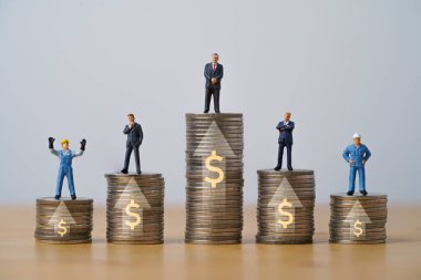 Worker and businessmen miniature figure standing on increasing coins stacking with up arrow and dollar sign for income salary various growth in different position , Human development concept. 