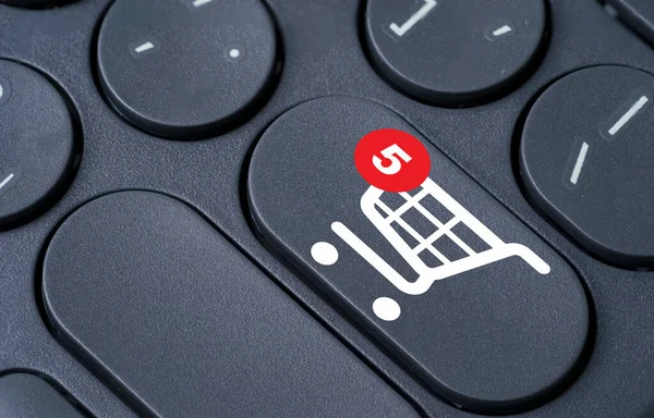 Shopping trolley cart and notification on computer keyboard for online shopping and e-commerce business concept.