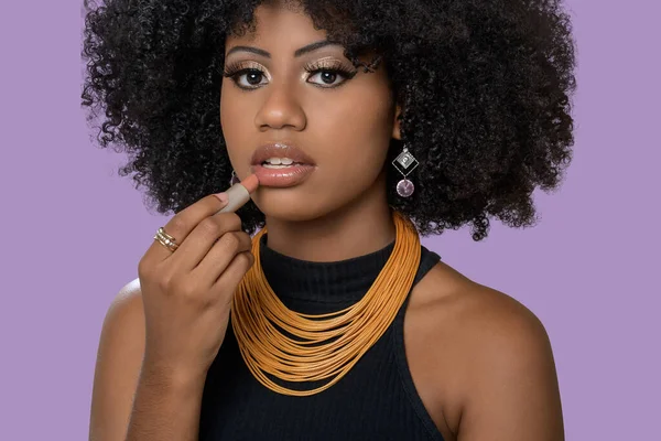 portrait of black woman makes stop hand gesture, isolated on gray background