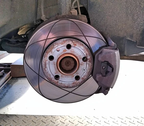 Ventilated brake disc mounted on the car. Brake shoe