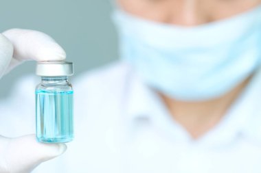Hand of doctor holding syringe and medicine bottle. Preparing for injection