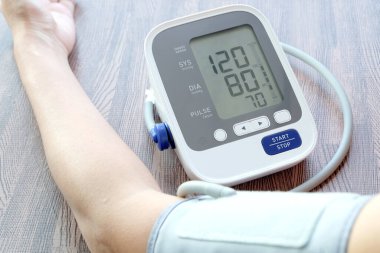 İnsan tansiyon monitörü ve kalp atış hızı monitörünü dijital basınç göstergesiyle kontrol eder. Sağlık ve Tıp Konsepti
