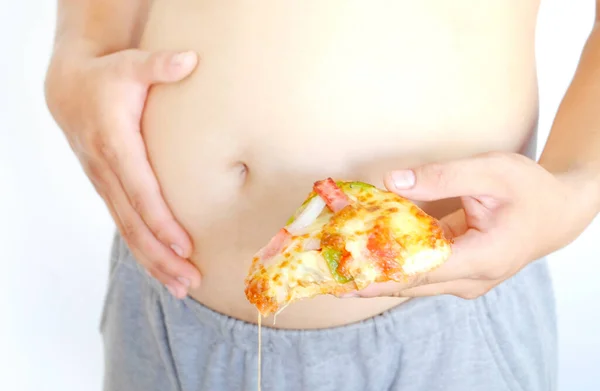 Fat man like to eat pizzas and enjoy eating Junk Food. His hand holding one piece pizza and boy is full. Pizza have high cholesterol, Health Concept.