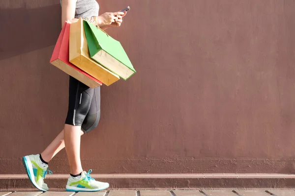 女人在网上用智能手机购物 时尚服装时尚 带上一个彩色购物袋 — 图库照片