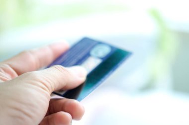 Hand of woman holds her credit card bank pay to shop for her credit card.